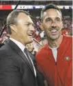  ?? Michael Zagaris / Getty Images 2018 ?? GM John Lynch and head coach Kyle Shanahan see each other socially.