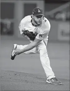  ?? JAE C. HONG/AP PHOTO ?? Los Angeles Dodgers starting pitcher Clayton Kershaw throws against the Atlanta Braves during the first inning of Game 2 of the National League Division Series on Friday at Los Angeles.