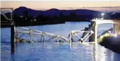  ??  ?? WASHINGTON: Crews survey the scene of a bridge collapse on Interstate 5 on Thursday near Mt Vernon, Washington.