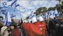  ?? Photo credit ?? Israelis protest against plans by Prime Minister Benjamin Netanyahu’s new government to overhaul the judicial system, outside the Israel’s parliament, in Jerusalem on Feb. 13.