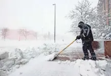  ?? ISAIAH J. DOWNING/ USA TODAY SPORTS ?? A worker clears snow in front of Ball Arena before the game between the Colorado Avalanche and the Los Angeles Kings.