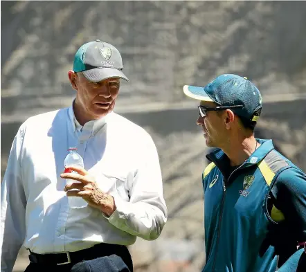  ??  ?? Australian coach Justin Langer, right, discusses issues with national selector Greg Chappell at a nets session.