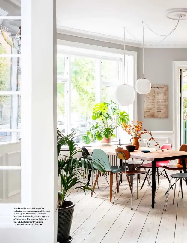  ??  ?? Kitchen A jumble of vintage chairs, collected over years, surround the table (a vintage find to which the owners have attached new legs), offering views of the garden. The pendant lights are the ‘VL45 Radiohus’ by Vilhelm Lauritzen for Louis Poulsen