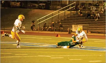  ?? PHOTO FOR THE RECORDER BY KAREN VANNI ?? Joseph Noriega makes a diving catch for a first down on a fourth down conversion for the Portervill­e High football team during its game against Kingsburg on Thursday, September 16, 2021, at Rankin Stadium.