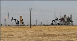  ?? The Associated Press ?? OIL FIELD: This July 30 photo, shows an oil field controlled by the Kurdish-led Syrian Democratic Forces (SDF), in Rmeilan, Hassakeh province, northeast Syria. The SDF, with air support from the U.S.led coalition, said Sunday that they had captured the...