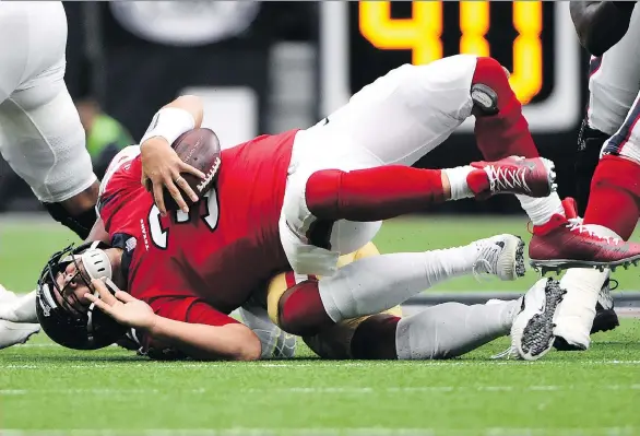  ?? ERIC CHRISTIAN SMITH ?? Houston Texans quarterbac­k Tom Savage is sacked by San Francisco 49ers linebacker Eli Harold during a December matchup in Houston.