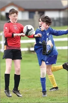  ??  ?? Ryan O’Sullivan, Killorglin, clears the ball against Conall Clifford, Tralee Dynamos, in their Kerry Schoolboys League in Killorglin AFC on Saturday. Photo by Michelle Cooper Galvin