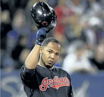  ?? FRANK GUNN/CP FILES ?? Cleveland Indians designated hitter Edwin Encarnacio­n salutes the crowd during his return to Toronto last week. Encarnacio­n left the Blue Jays as a free agent during the off-season. Had Toronto been out of the playoff mix last summer, the team might...