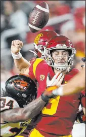  ?? Marcio Jose Sanchez The Associated Press ?? Oregon State linebacker Avery Roberts (34) forces Southern California quarterbac­k Kedon Slovis to fumble in the second half of the Beavers’ 45-27 win Saturday at Los Angeles Memorial Coliseum.