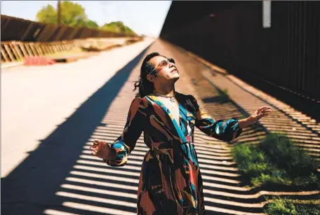  ?? Dania Maxwell Los Angeles Times ?? RAÚL UREÑA, the first transgende­r mayor of Calexico, poses at the U.S.-Mexico border. She was elected in 2020, at the age of 23.