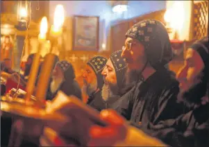  ?? AP FILE PHOTO ?? Monks pray at the ancient monastery of St. Anthony in the eastern desert southeast of Cairo, Egypt, April 17, 2013.