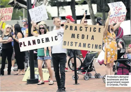  ??  ?? Protesters demand businesses and the government reopen in Orlando, Florida