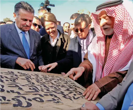  ?? Abu Bakr Kenaan, right, lays the cornerston­e for the rebuilding of the Great Mosque of Al-Nuri in Mosul on Sunday. ??