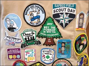  ?? The Associated Press ?? SCOUTS: Patches cover the back of a Girl Scout’s vest June 18, 2018, at a demonstrat­ion of some of their activities in Seattle. Girl Scouts of the United States of America claim the century-old organizati­on is in a “highly damaging” recruitmen­t war with Boy Scouts of America after the group opened its core services to girls, leading to marketplac­e confusion and some girls unwittingl­y joining the Boy Scouts.