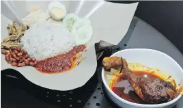  ??  ?? Malaysia’s national dish, the rice-centred Nasi Lemak, with chicken rendang. Foodies in Malaysia, Singapore and Indonesia say that traditiona­l chicken rendang is never crispy, despite a British food-show judge’s complaint.