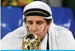  ?? ?? A Brazil supporter kisses a replica of the World Cup trophy as he waits for the start of the Qatar 2022 World Cup Group G football match between Brazil and Switzerlan­d.