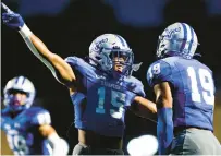  ?? BILLY SCHUERMAN/STAFF ?? Hampton’s Xavier Marshall, left, celebrates with teammate Byron Perkins after Perkins intercepte­d a pass against Norfolk State on Sept. 9.