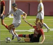  ?? PETE BANNAN — DIGITAL FIRST MEDIA ?? Conestoga’s Sydney Sloan sidesteps Penncrest’s Logan Morris’ slide early in a game between the teams Tuesday at Teamer Field. The Pioneers won 1-0 to move into a tie with the Lions at the top of the Central League.