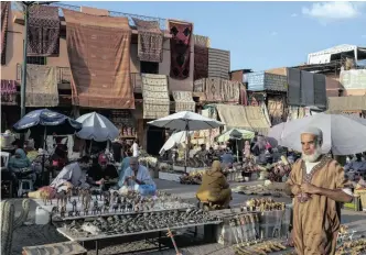  ??  ?? The market in Marrakech’s ancient medina. The bustling medina changes from juice and shopping in the day, to sheep’s head soup and noise at night. | The New York Times