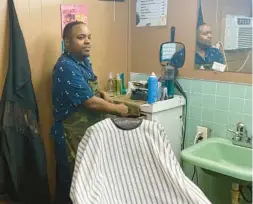  ?? AIDAN BUSH/FRESH TAKE BUSINESS ?? Andrew Kenjana Miller cleans up his barbershop Poetic Cuts, in High Springs, Fla., while waiting for potential customers to arrive on Feb. 23.