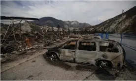  ?? Photograph: Darryl Dyck/AP ?? ‘We felt awestruck by the ash floating from the sky, covering our decks, outdoor tables and car windshield­s.’ Vehicles destroyed by wildfire near Lytton, British Columbia, 15 August 2021.