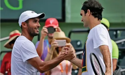  ?? Photograph: Adrian Escarate/Courtesy of Adrian Escarate ?? Adrian Escarate greets Roger Federer after warming up for the 2017 Miami Open final.