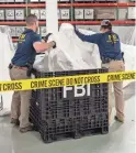  ?? FBI VIA AP ?? FBI special agents process material recovered from the object that was recovered off the coast of South Carolina on Thursday in Quantico, Va.