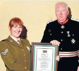  ??  ?? ●●Corporal Karen Mainwaring of the Territoria­l Army received the Lord Lieutenant’s certificat­e from Colonel the Hon Lord Shuttlewor­th
