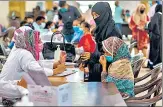  ?? BLOOMBERG ?? Health workers register people to receive a dose of the Covid-19 vaccine at a centre set up in Karachi, Pakistan.