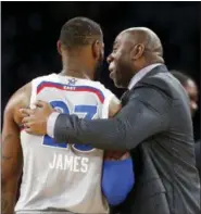  ?? ASSOCIATED PRESS FILE ?? Magic Johnson reacts as he talks with Eastern Conference’s LeBron James during the first half of the NBA All-Star game in New Orleans.
