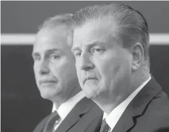  ?? DARRYL DYCK, THE CANADIAN PRESS ?? Canucks GM Jim Benning, front, and head coach Willie Desjardins talk about the team’s new faces on the eve of training camp Thursday in Vancouver.