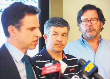  ?? Ned Gerard / Hearst Connecticu­t Media ?? Ian Hockley, center, father of Sandy Hook Elementary School student Dylan Hockley, and Bill Sherlach, right, husband of Sandy Hook school psychologi­st Mary Sherlach, look on as attorney Josh Koskoff speaks a press conference in Bridgeport in March.