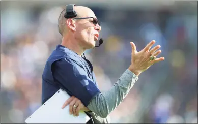  ?? Stew Milne / Associated Press ?? University of Connecticu­t interim head football coach Lou Spanos gestures from the sideline during a game against Purdue on Sept. 11 in East Hartford.