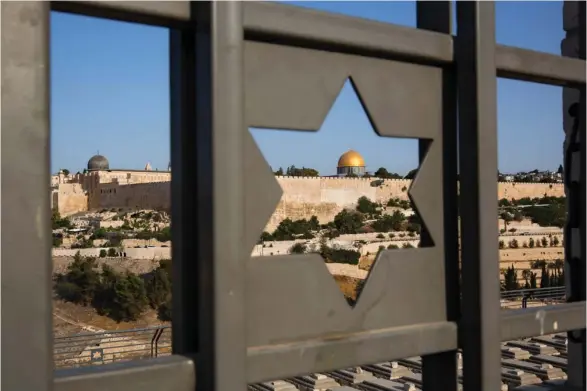  ?? (Photo by Oded Balilty, AP, File) ?? In this July 25, 2017 file photo, Jerusalem's Old City is seen trough a door with the shape of star of David. Turkey and the Palestinia­ns have warned of dire diplomatic repercussi­ons in the Middle East if President Donald Trump goes ahead with a...