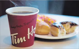  ?? JONATHAN HAYWARD THE CANADIAN PRESS ?? Tim Hortons parent company pleased with sales growth.
