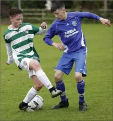  ??  ?? Greystones’ Michael Gray competes with Roundwood’s Nathan Quinn.