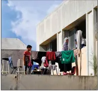  ?? (AP/Hassan Ammar) ?? A family displaced from south Lebanon stands on the roof of a school being used as a shelter in the southern port city of Tyre, Lebanon, on Friday.