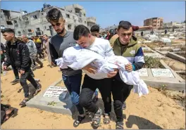  ?? AHMAD HASABALLAH — GETTY IMAGES ?? People mourn as they receive the dead bodies of victims of an Israeli strike on Thursday in Rafah, Gaza. Despite internatio­nal warnings, Israeli forces continue to target the city.