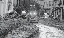  ?? Salvatore Laporta/associated Press ?? Machinery removes mud from a road Saturday after heavy rainfall triggered landslides that collapsed buildings and left as many as 12 people missing on the Italian island of Ischia.