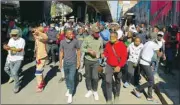  ??  ?? Stick-wielding protesters march through the streets as violence following the jailing of former South African president Jacob Zuma spread to the country’s main economic hub in Johannesbu­rg, yesterday.