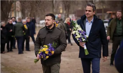  ?? Photograph: Ukrainian Presidenti­al Press Service/Reuters ?? Ukraine’s president, Volodymyr Zelenskiy, and the Greek prime minister, Kyriakos Mitsotakis, visit a makeshift memorial to the victims of a drone strike that heavily damaged an apartment building in Odesa. A subsequent Russian missile attack on the port of Odesa struck near the leaders.