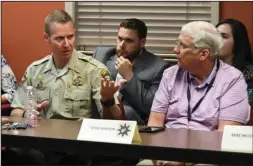  ?? The Sentinel-Record/Grace Brown ?? CRISIS INTERVENTI­ON: Garland County Under Sheriff Jason Lawrence, left, discusses crisis interventi­on training for law enforcemen­t officers Wednesday as Garland County Deputy Prosecutor Trent Daniels and Steve Arrison, CEO of Visit Hot Springs, listen during a roundtable meeting of public officials and community leaders at the Hot Springs Police Department.