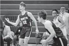  ?? [BRYAN TERRY/ THE OKLAHOMAN] ?? Edmond North's Sam Walker (left) celebrates a 3-pointer during the championsh­ip game in the Putnam City Invitation­al against Putnam City West on Saturday.