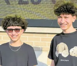  ?? AP ?? Adam Mortada (left) and his older brother Hussein Mortada stand outside Dearborn High School.