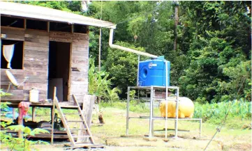  ??  ?? Storage tanks at a longhouse to collect rain water.