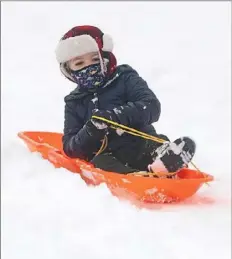  ?? Pittsburgh Post-Gazette ?? Ethan Wendell, 3, of Greenfield, sleds down the hill on Thursday in Schenley Oval in Oakland.