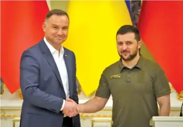  ?? AP PHOTO/EFREM LUKATSKY ?? Ukrainian President Volodymyr Zelenskyy, right, and Polish President Andrzej Duda shake hands during a news conference after their meeting in Kyiv, Ukraine on Sunday.