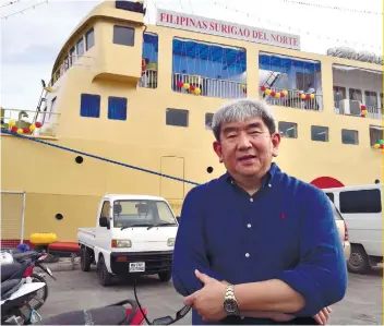  ??  ?? PHOTO BY ARNI ACLAO NEW VESSEL: Cokaliong Shipping Lines Inc. founder and CEO Chester Cokaliong pose with the new M/V Filipinas Surigao Del Norte in his background during the vessel’s blessing and inaugurati­on.