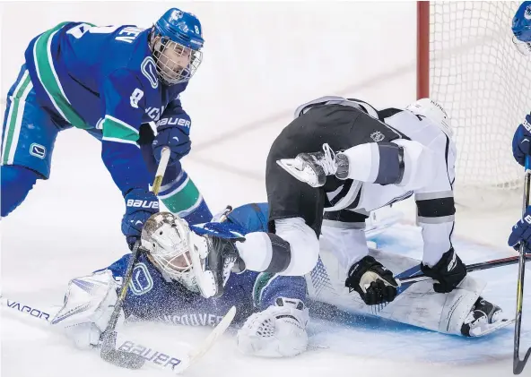  ?? — THE CANADIAN PRESS ?? Goaltender Jacob Markstrom and other members of the Canucks were under siege Tuesday thanks to the Los Angeles Kings’ overly physical play, which bubbled over in the second period when the Kings’ Trevor Lewis hit Canucks star Brock Boeser from behind.