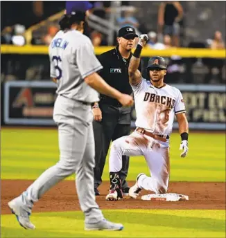  ?? Norm Hall Getty Images ?? ARIZONA’S David Peralta is excited after hitting a double in the first inning against the Dodgers, but it was his tiebreakin­g, two-run home run in the eighth inning that was the big blow.